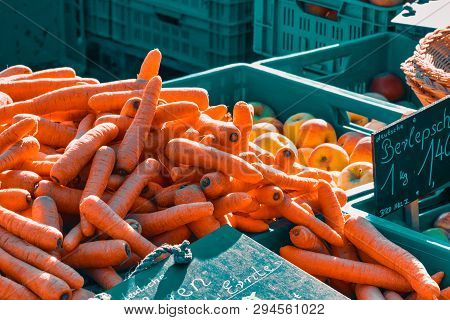 Rheydt, Germany - October 08, 2016: Fresh Carrots Are Piled Up In A Blue Plastic Crate For Sale