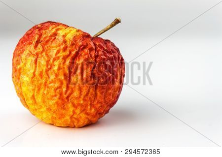 Wrinkled Apple Texture With White Background. Shriveled Apple. Old Apple. Isolated On White.