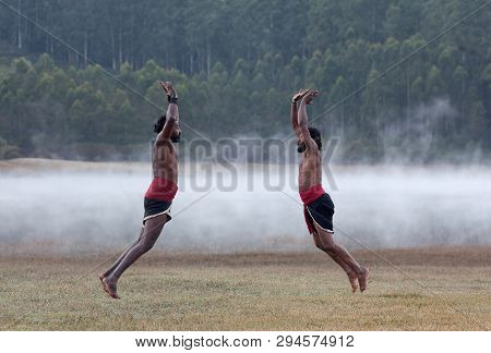 Indian Fighters Jumping Up During Kalaripayattu Marital Art Demonstration In Kerala, South India