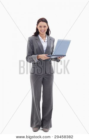 Businesswoman looking happy with a laptop against white background