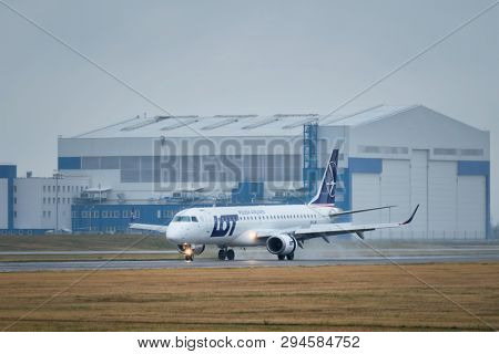 MINSK, BELARUS - JUNE 15, 2018: LOT Polish airlines flight Embraer 195 plane taxi on runway in National Airport Minsk