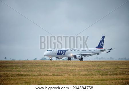 MINSK, BELARUS - JUNE 15, 2018: LOT Polish airlines flight Embraer 195 plane taxi on runway in National Airport Minsk