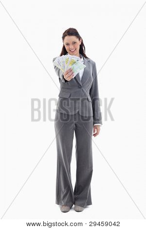 Happy businesswoman with a lot of bank notes in her hand against white background