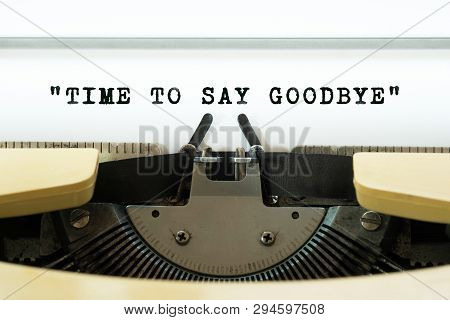 Time To Say Goodbye Word Typed On A Yellow Vintage Typewritter. Business Concept.
