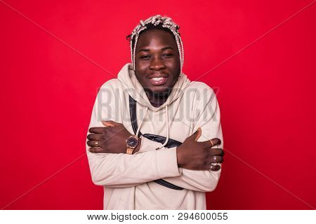 Handsome African Man Freezing Isolated On Red Background