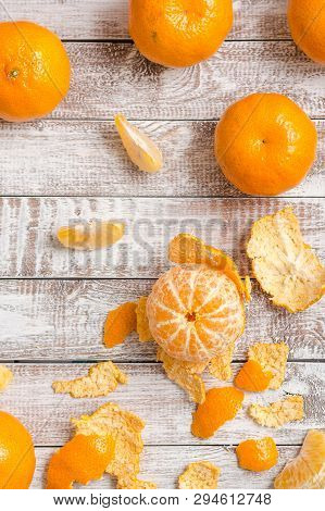 Peele Dripe Tangerines On Wooden Light Background