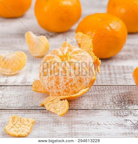 Peele Dripe Tangerines On Wooden Light Background