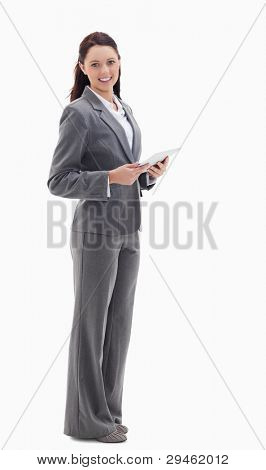 Profile of a businesswoman smiling with a touch pad against white background