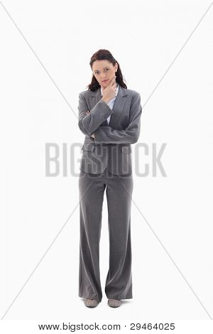 Businesswoman with the hand on her chin against white background