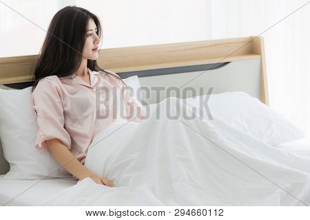 Young And Beautiful Asian Woman Lay Down On Bed In The Morning After Awake From Sleeping, Looking Ou