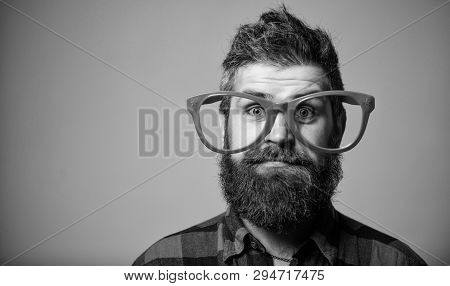 Nerd Concept. Hipster Looking Through Of Giant Pink Eyeglasses. Man Beard And Mustache Face Wear Fun