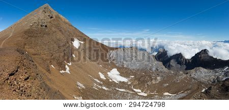 Panorama With Summit Of Uri Rotstock Mountain In Swiss Alps, Blue Sky, Sea Of Fog