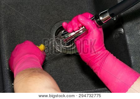 The Process Of Washing The Dark Sink, Hands Close-up. A Man In Pink Gloves Washes A Sink. Cleaning, 