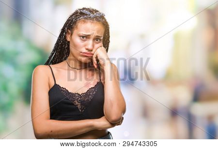 Young braided hair african american with pigmentation blemish birth mark over isolated background looking stressed and nervous with hands on mouth biting nails. Anxiety problem.