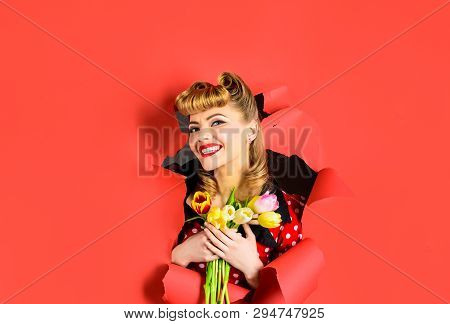 Smiling Retro Woman Looking Through Hole In Paper. Pin Up Woman With Tulips Looking Through Paper. P
