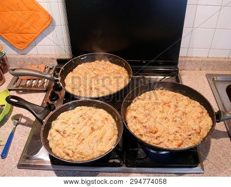 Big Pans With The Food Named Frico A Typical Italian Recipe With Potatoes And Cheese
