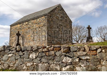Stone House And Cemetery With Celtic Cross