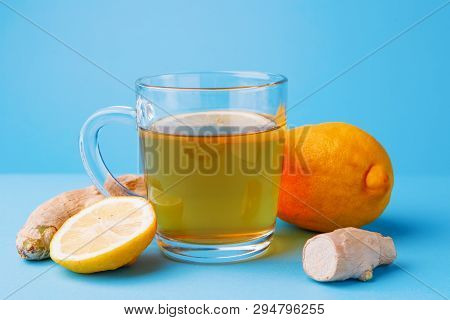 Tea, Lemon And Ginger On A Blue Background. Concept Helth And Theatment
