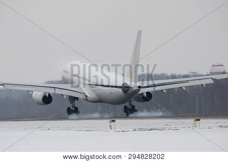 Wide-body Airplane Landing On Runway With Smoke From Chassis In Winter Time, Back View, Radar And Cl