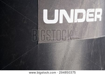 Black Rubber Background With White Text - Under.