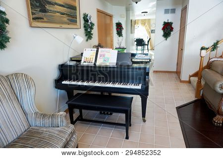 Joliet, Illinois / United States: December 25, 2017: A Black Schumann Grand Piano Stands In The Livi