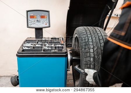 Excellent Balancing Wheel On Zero. Technician Spins A Car Wheel. The Tool For Repair - Lead Small We