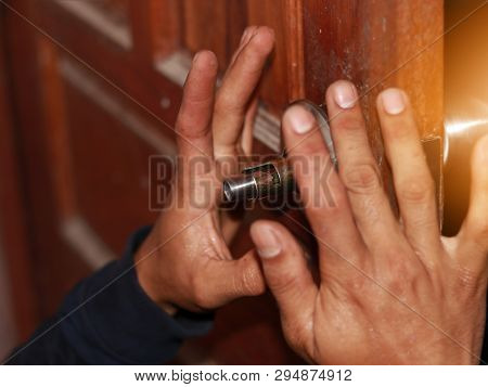 On Selective Focus At  Latch Of The Old Bathroom Door Latch Repair Technicians, By Replacing The Fau
