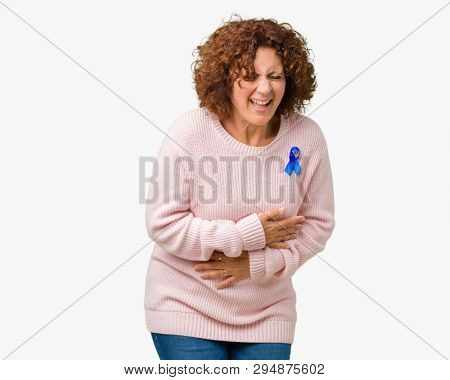 Middle ager senior woman wearing changeable blue color ribbon awareness over isolated background Smiling and laughing hard out loud because funny crazy joke. Happy expression.