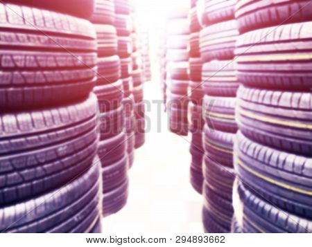 Abstract Blurred Background With Car Tires For Sale. Blur Photo Of Lots Of Car Tires In The Shop For