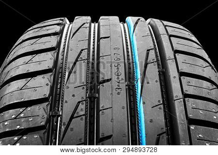 Studio Shot Of A Set Of Summer Car Tires On Black Background. Tire Stack Background. Car Tyre Protec