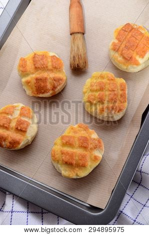 Hungarian Traditional Cheese Pogacsa With Paper On A Baking Tray