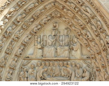 Paris, France Notre Dame Cathedral Facade Of The Statue Of The Saint. Unesco World Heritage