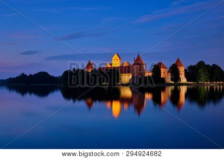 Evening view of Trakai Island Castle in lake Galve illuminated in the night, Lithuania