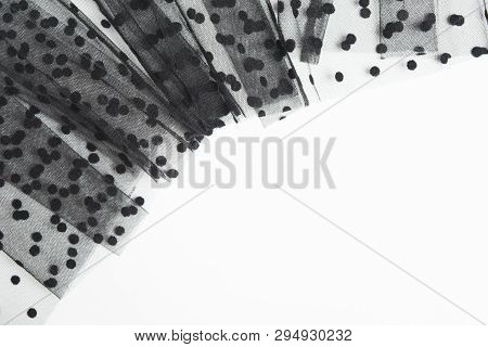 Black Textile Tulle Material On White Background. Shape Of Tulle Fabric With Copy Space. Flat Lay. T