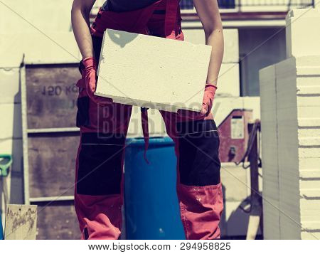 Unrecognizable Woman Working On Construction Site, Building House, Installing Gray Airbricks. Indust