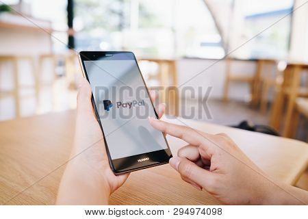 Chiang Mai, Thailand - Jan. 19,2019: Woman Holding Huawei With Paypal Apps On The Screen. Paypal Is 