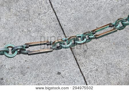 Chain Links On The Background Of Paving Slabs