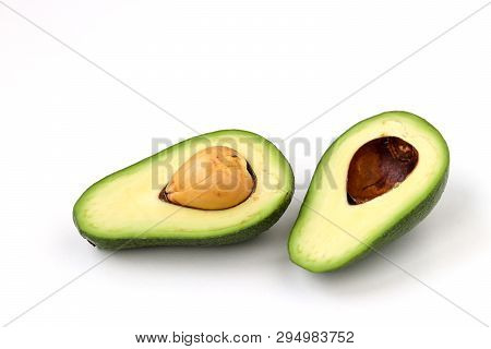 Two Halves Of Ripe Avocado Lokaled On A White Background
