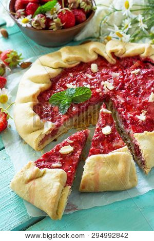 Fresh Homemade Strawberries Galette With Nut Cream On The White Kitchen Table.