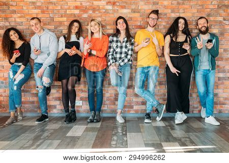 Millennials Happy Wealthy Generation. Young Cheerful People In Casual Outfits, Standing Relaxed, Hol