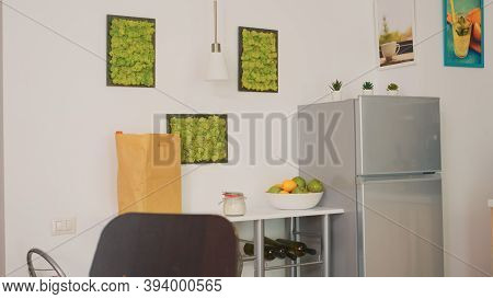 Bowl With Freshs Fruits In Empty Kitchen. Modern Dining Room With Coffee Machine In Cozy Interior Wi