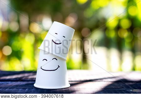 Two Smiling Cups. Emotion Symbol Of Children And Parents
