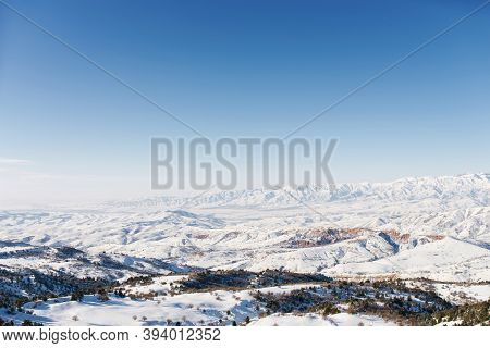 Panorama Of The Tien Shan Mountains Covered With Snow In Sunny Weather. Winter Landscape In The Moun
