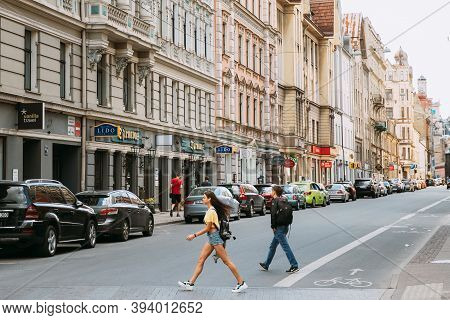 Riga, Latvia - June 9, 2019: People Cross The Road On The Dzirnavu Iela Street. Young Woman Walking 