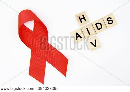 Red Ribbon-symbol And Wooden Cubes With The Text 