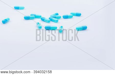 Selective Focus On Blue Capsule Pill On White Background. Pharmaceutical Industry. Pharmacy Products