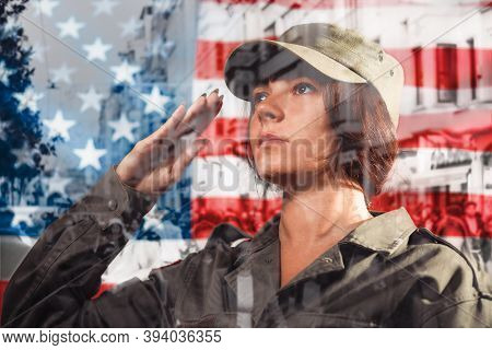 Usa Celebration. Portrait Of A Female Soldier Saluting, Against The Background Of The American Flag.