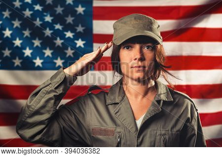 Veterans Day, Memorial Day, Independence Day. Portrat Of Female Soldier Saluting Against The Backgro