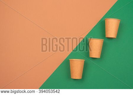 Set Of Eco-friendly Takeaway Beverages Cups - Kraft Paper Coffee Cups On Green And Brown Background 