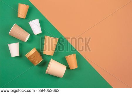 Different Eco-friendly Takeaway Beverages Cups - Kraft Paper Coffee Cups On Green And Brown Backgrou